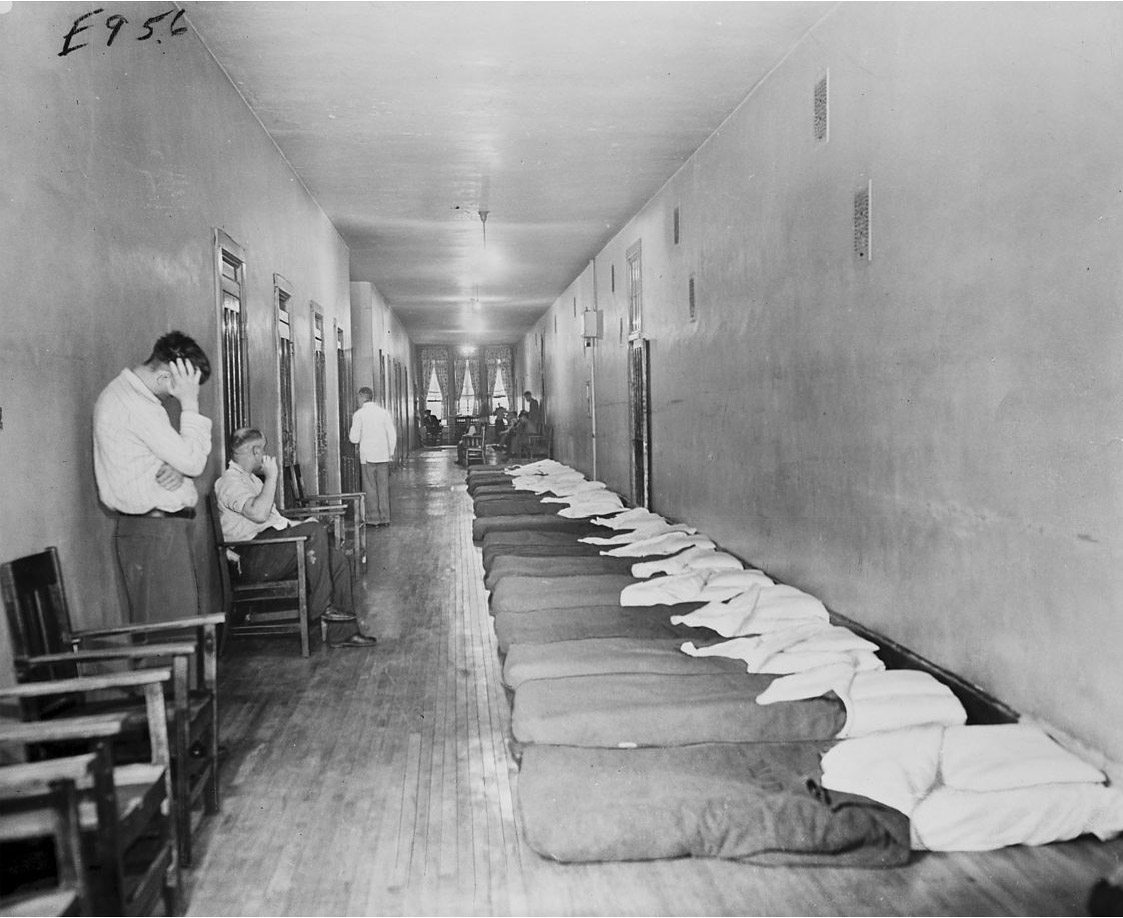 This February 1947 photo, taken inside the Chicago State Hospital, shows the poorly ventilated, narrow and congested hallways where some patients slept. (Chicago Daily News photo, Chicago History Museum, ICHi-16073)