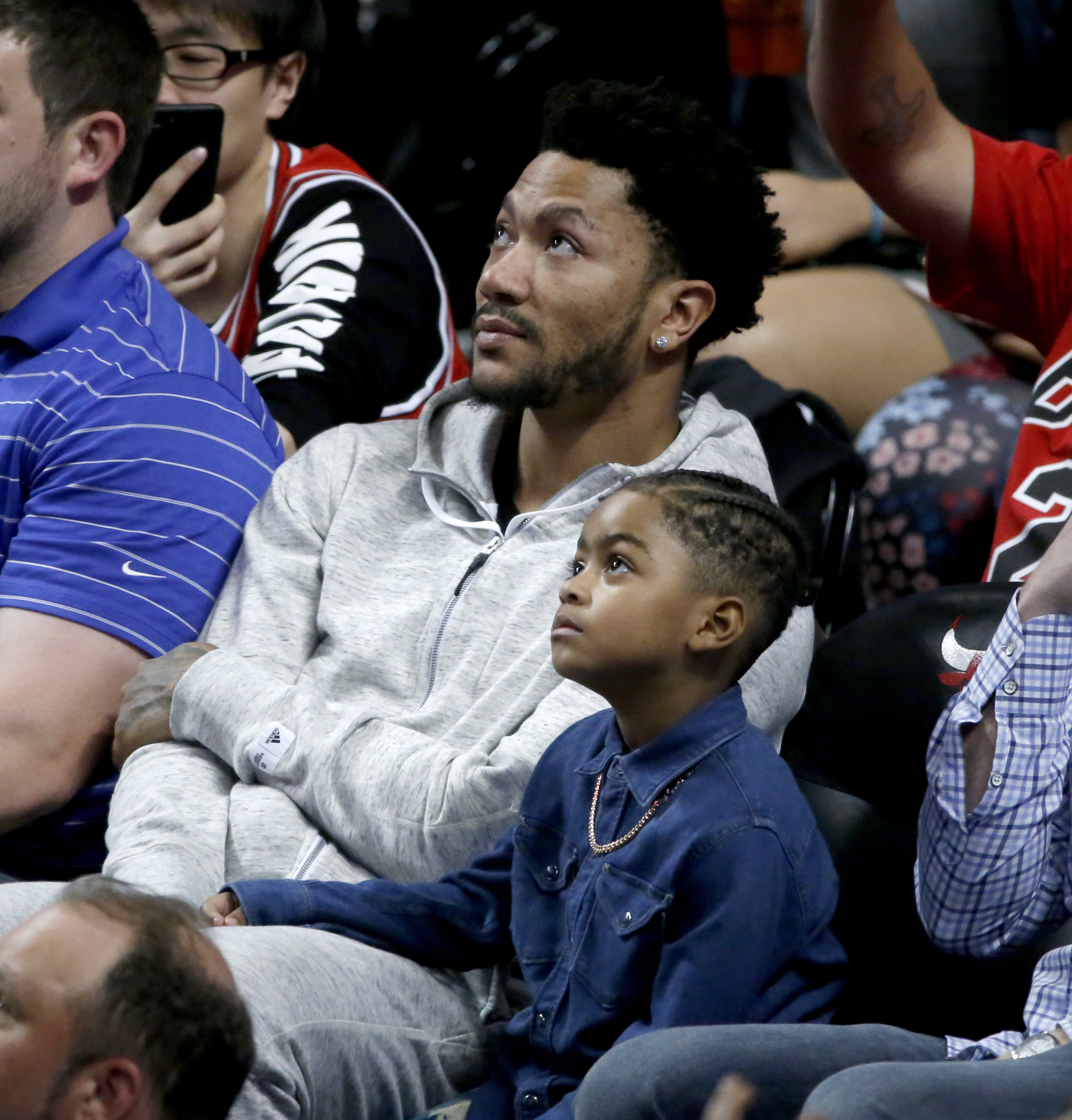 Derrick Rose and his son Derrick Rose Jr., known as PJ, during Game 4 of an NBA playoff series between the Boston Celtics and Chicago Bulls on April 23, 2017. (Charles Rex Arbogast/Associated Press)